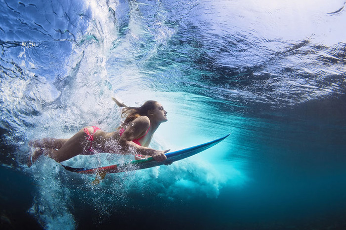 Surfer girl underwater