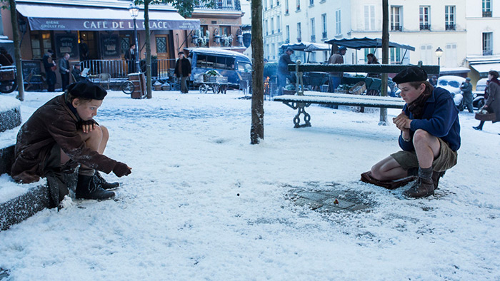 In more innocent times, Jojo and Maurice play marbles