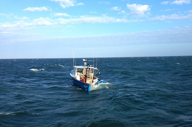 A rescue boatcrew from Coast Guard Station Montauk saved three fishermen from their sinking boat off Gardiners Island