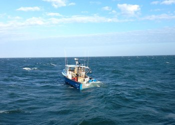 A rescue boatcrew from Coast Guard Station Montauk saved three fishermen from their sinking boat off Gardiners Island