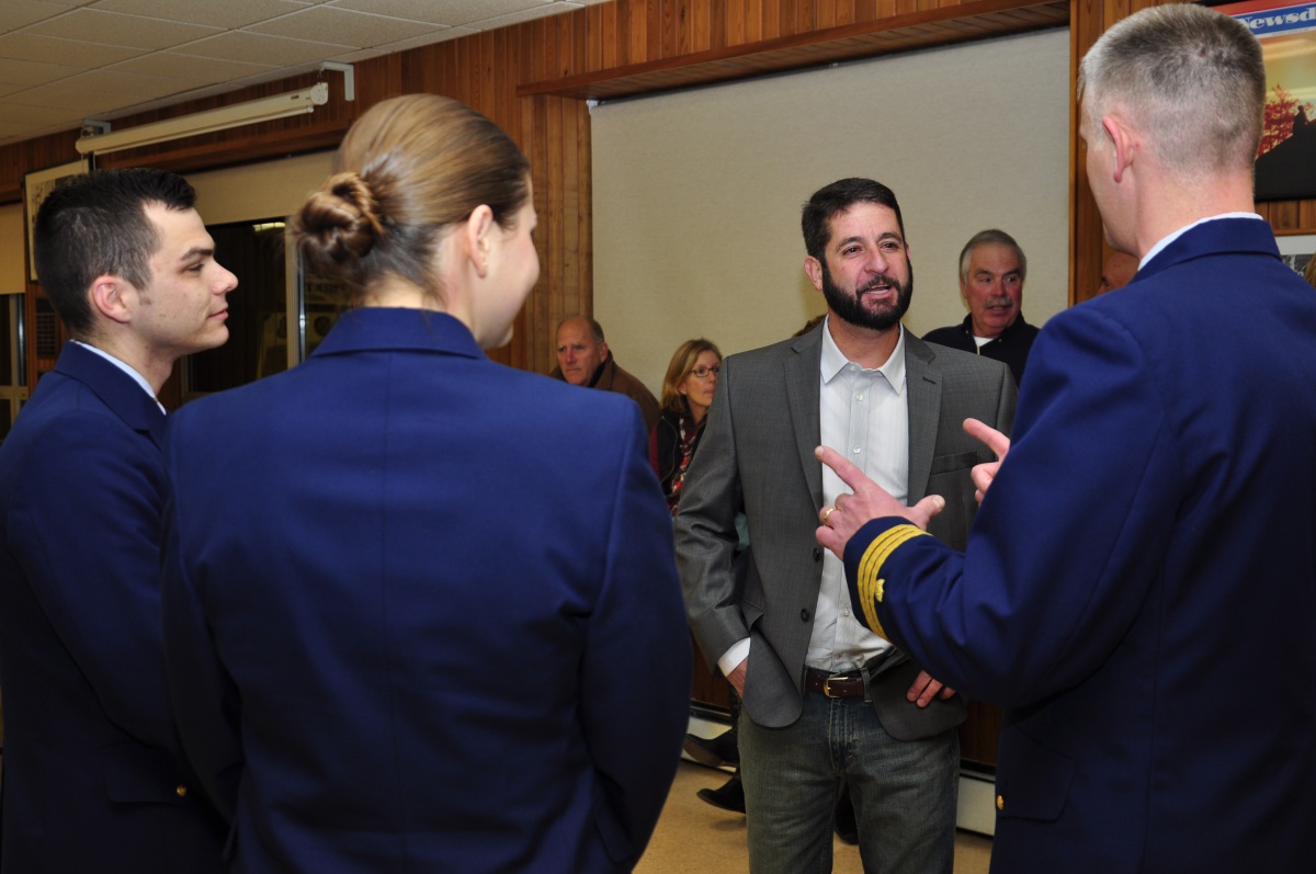 John Aldridge, a Montauk lobsterman, converses with members of the Coast Guard at the Montauk Fire Department, Friday evening.