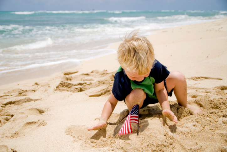 Boy with American Flags on a Beach