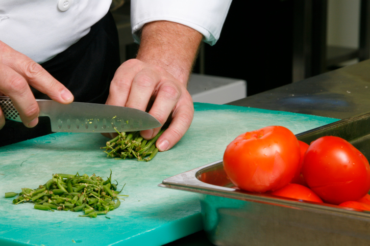 Close up of a person chopping vegetables