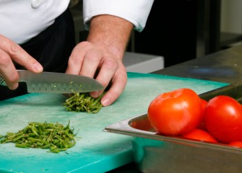 Close up of a person chopping vegetables
