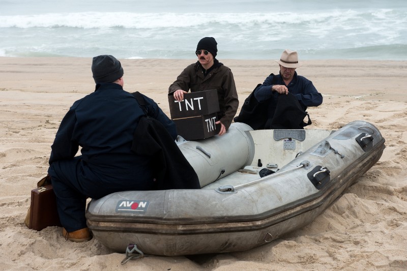 The Nazi saboteurs go over their story before their encounter with Coast guardsman John Culver.