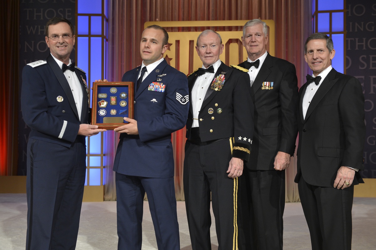 New York Air National Guard Staff Sgt. Christopher Petersen receives a plaque recognizing him as the USO's National Guardsman of the Year for 2013 from National Guard Vice Chief , Lt. Gen. Joseph Lengyel during the USO's annual gala October 25. Also pictured are General Martin Dempsey, the Chairman of the Joint Chiefs of Staff, General Richard Myers, USAF (Ret) and USO CEO and President Sloan Gibson.
