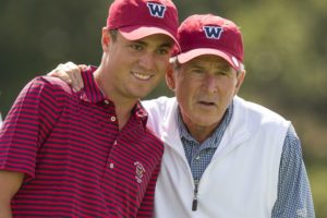 Former President George W. Bush lines up a putt with Justin Thomas during a practice round with the USA Walker Cup team at the 2013 Walker Cup at National Golf Links of America in Southampton on Thursday. ©USGA/John Mummert