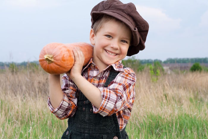 kid with pumpkin