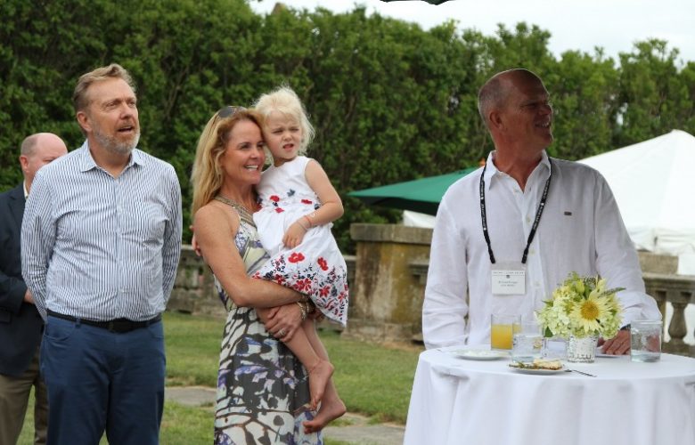 Homeowners and hosts Rich Hogan and Carron Sherry welcoming guests and toasting Barbara J. Slifka