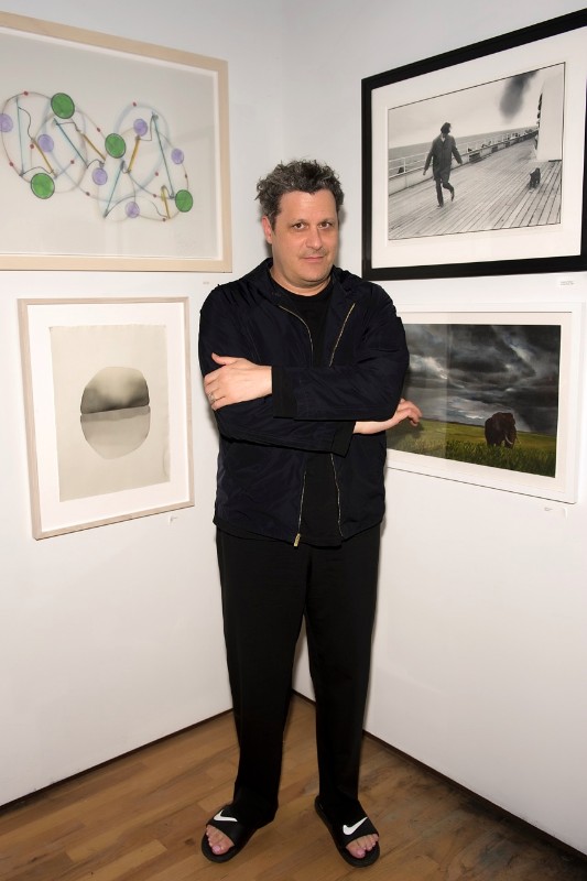 Designer Isaac Mizrahi in the gallery amid the donated auction art for which he was the auctioneer.