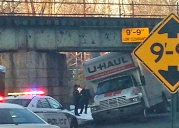 A U-Haul gets stuck under a bridge in East Hampton.