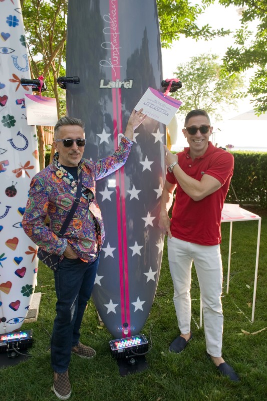 Guests Simon Doonan and Jonathan Adler strike a pose with some of the one-of-a-kind paddle boards that were part of the evening's auction items.