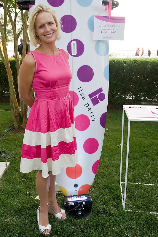 Jeanine Pepler poses with the Lisa Perry paddleboard.
