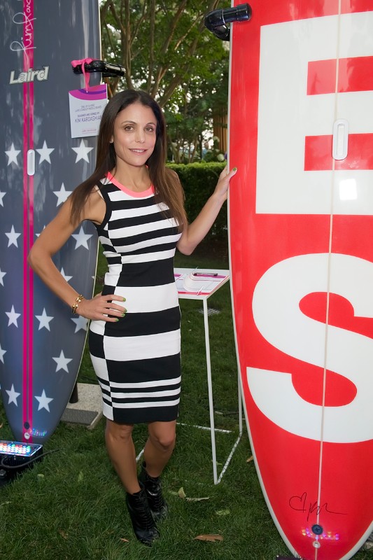 Bethenny Frankel with YES the stand up paddle board she designed.