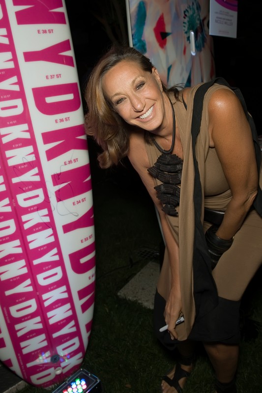 Donna Karan signing the paddle board she designed.