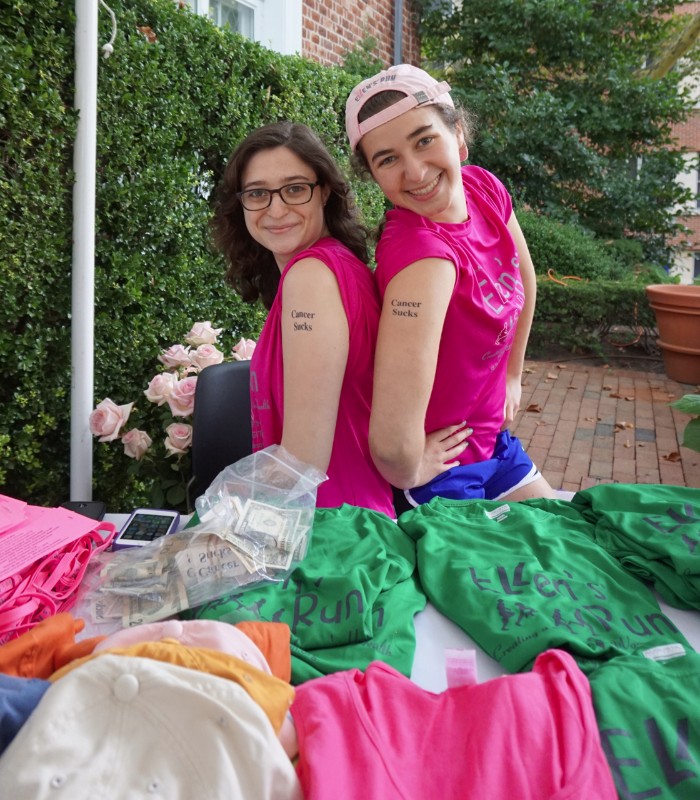 Rachel Kupfer and Yafi Shafer-Sull, volunteers selling shirts and other Ellen's Run memorabilia