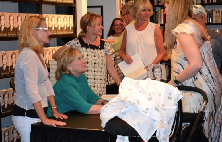 Hillary Clinton meets a mother and baby.