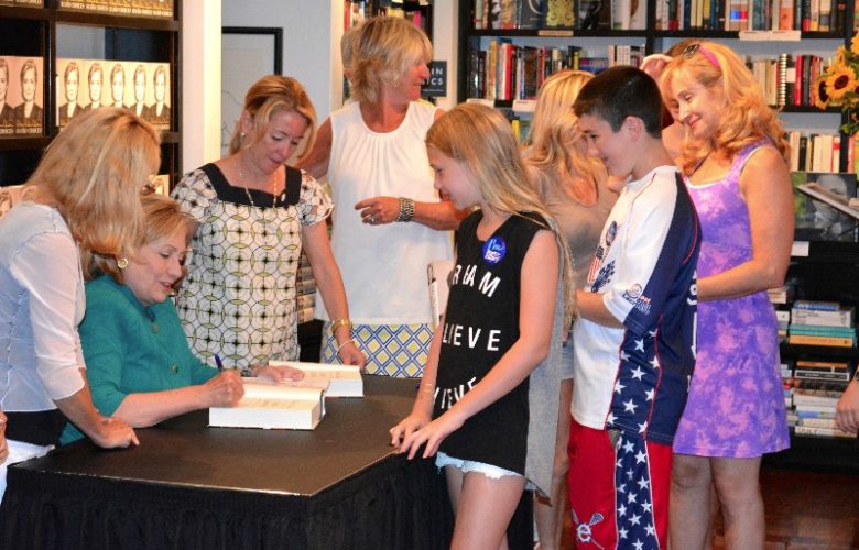 Hillary Clinton autographs "Hard Choices" for young fans.