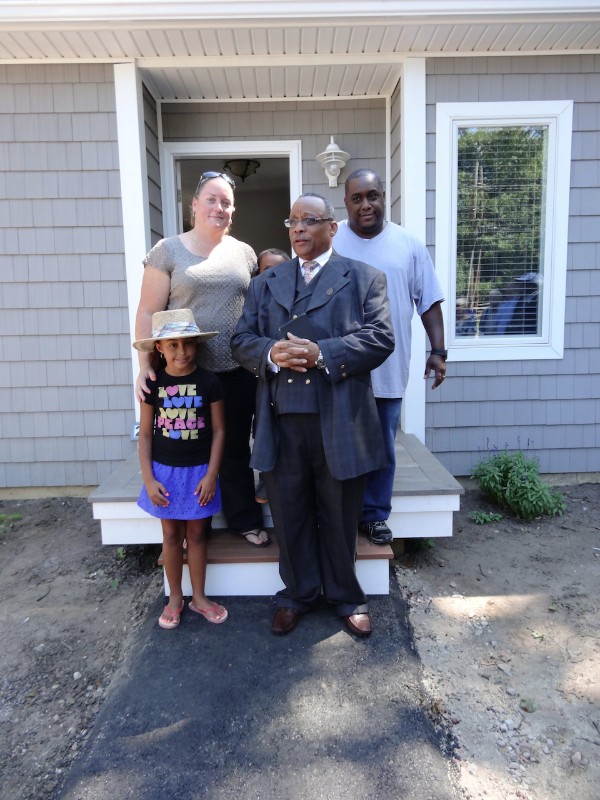 Alice, Kelley, Alexis (behind) and Randy Davis with the First Baptist Church Reverend H. G. McGhee just before his blessing of the house.