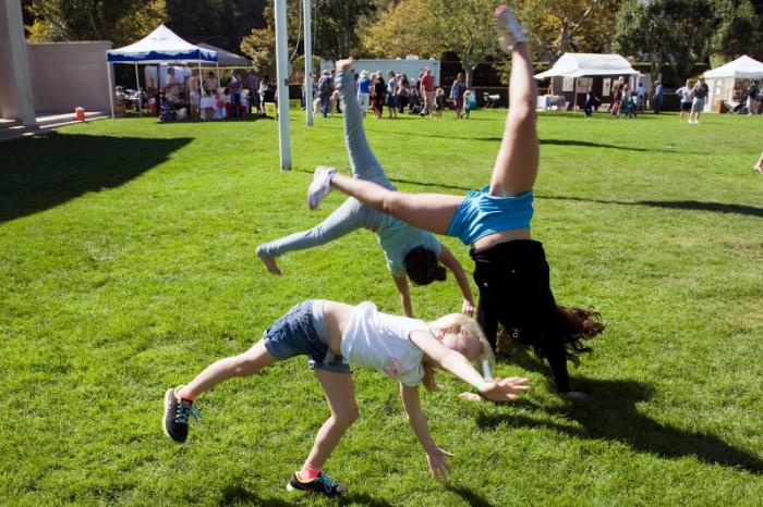 Three girls, Natalie Samlihan age 5, Rachel Barrale, age 12, and Amanda Lobalsamo, age 12, were so happy they were cartwheeling on the green grass amid the SeptemberFest festivities.