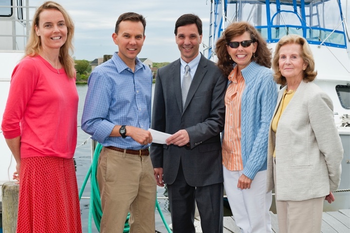 Peconic Baykeeper Board members Maureen Sherry, Dan Guilizio, Nancy Hébert and Phyllis Toohey, present Dr. Christopher Gobler with a grant for a dedicated shellfish spawner sanctuary.
