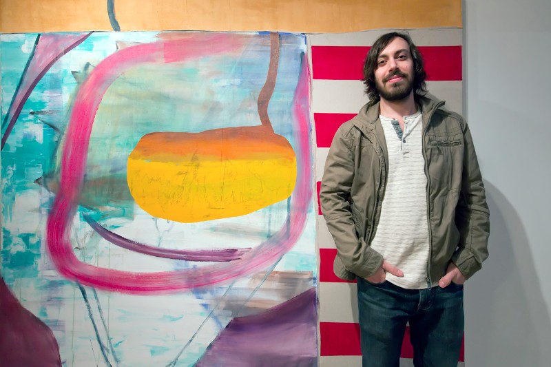 The artist Jonathan Beer with one of the paintings, "Burlap Flag", currently on view at Tripoli Gallery.