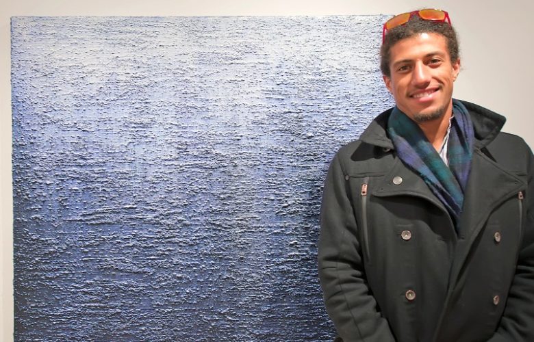 Gallery owner and curator of the exhibition Attitudes, Tripoli Patterson with an Eric Freeman painting.