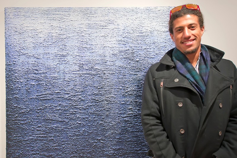 Gallery owner and curator of the exhibition Attitudes, Tripoli Patterson with an Eric Freeman painting.