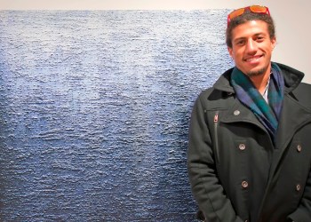 Gallery owner and curator of the exhibition Attitudes, Tripoli Patterson with an Eric Freeman painting.