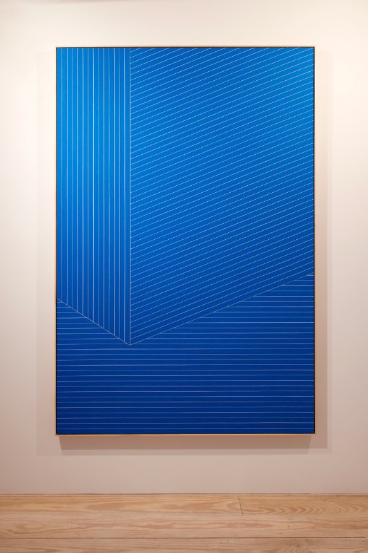 "100 Cents on the Dollar," is the work of Isaac Brest, using painters tape, drywall and wood.