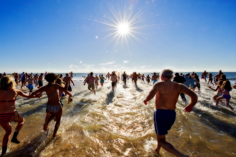 And there they go, splashing and shouting, as they plunged, en masse, into the icy December waters at Coopers Beach for this year's Polar Bear Plunge.