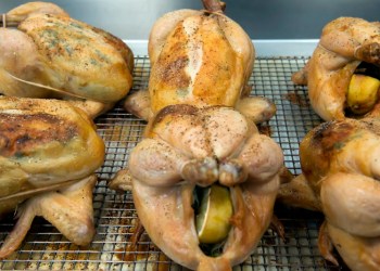 The roasted chicken after reaching the internal temperature are removed from the oven and let to stand