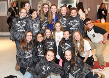 Kayla Mitchell poses with her friends who show their support with a thumbs up