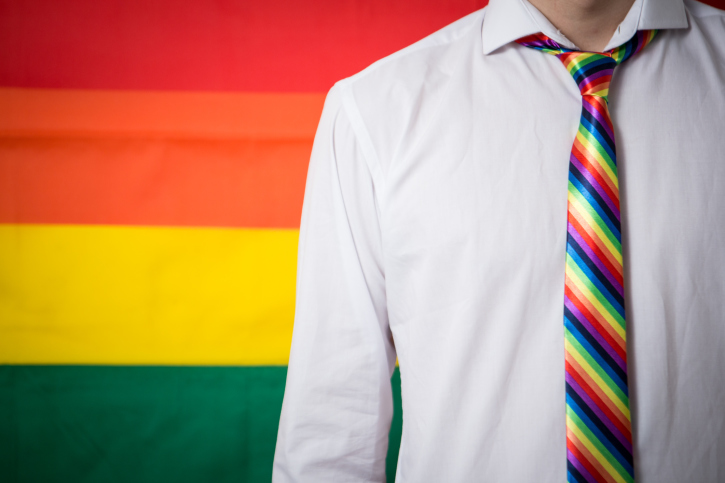 Man wearing shirt and rainbow tie