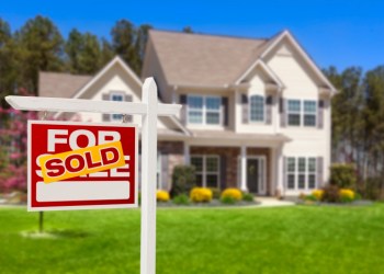 Sold Home For Sale Real Estate Sign and House