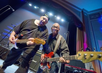 Pat DiNizio leaning in for some hot licks with bassist Severo Jornacion