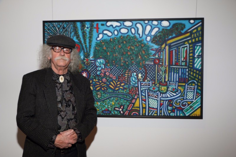 Artist David Slater stands by one of his many bold and energized paintings during the opening of his solo show entitled "Something Old, Something New" at the Peter Marcelle Project.