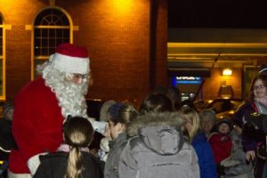 Santa Claus is greeted by the children of Westhampton Beach as he arrived at the Village Green for the annual Menorah and Christmas tree lighting ceremony on Saturday evening.