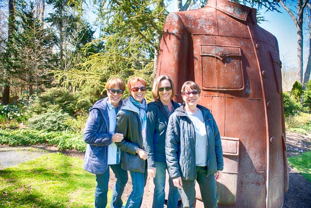 Diane Dalton, Janet Rogove, Kim Voelker and Joan Cartin, made a special sisters day outing to LongHouse Reserve, posing here with the over-sized, cast iron Mao Jacket, a new piece of sculpture by artist Sui Jianguo, at eh LongHouse Reserve.
