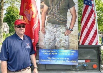 Chris Haerter, father of one of Sag Harbor's fallen sons, with a banner of his son
L Cpl. Jordan Haerter.