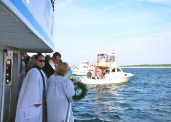 Rev. Denis Brunelle, Cantor Debra Stein and Pastor Bill Hoffmann placing the Memorial Wreaths in memory of Capt. Carl Darenberg, Capt. Bill Holzman, Capt. Harry Clemenz, James Wood, Dennis O'Connor, Ed Orr, Joseph Keckeisen at the Harbour Buoy 