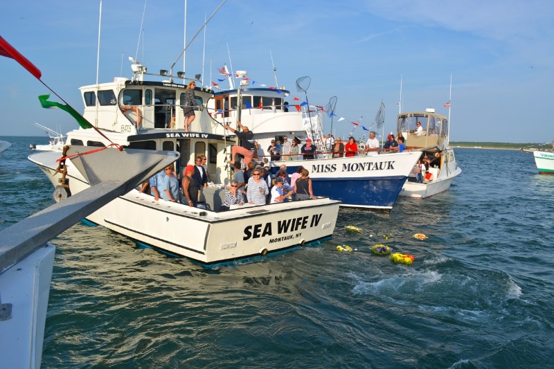 The laying of the "Remembrance Wreaths" at the Harbor Buoy after the Blessing with "Sea Wife IV" and "Miss Montauk" in the background.