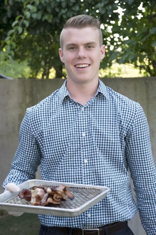 Bryson Burkholder was cooking up the bacon for the Topping Rose House mini sandwiches.