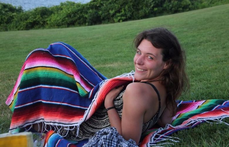 Jules Sheehan warms herself from the cool shore breeze.