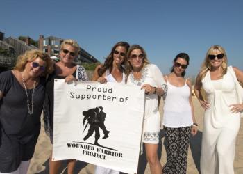 Alissa Straino of Inside Out, with the women behind the event, holding a Wounded Warrior banner, working to make a difference.
