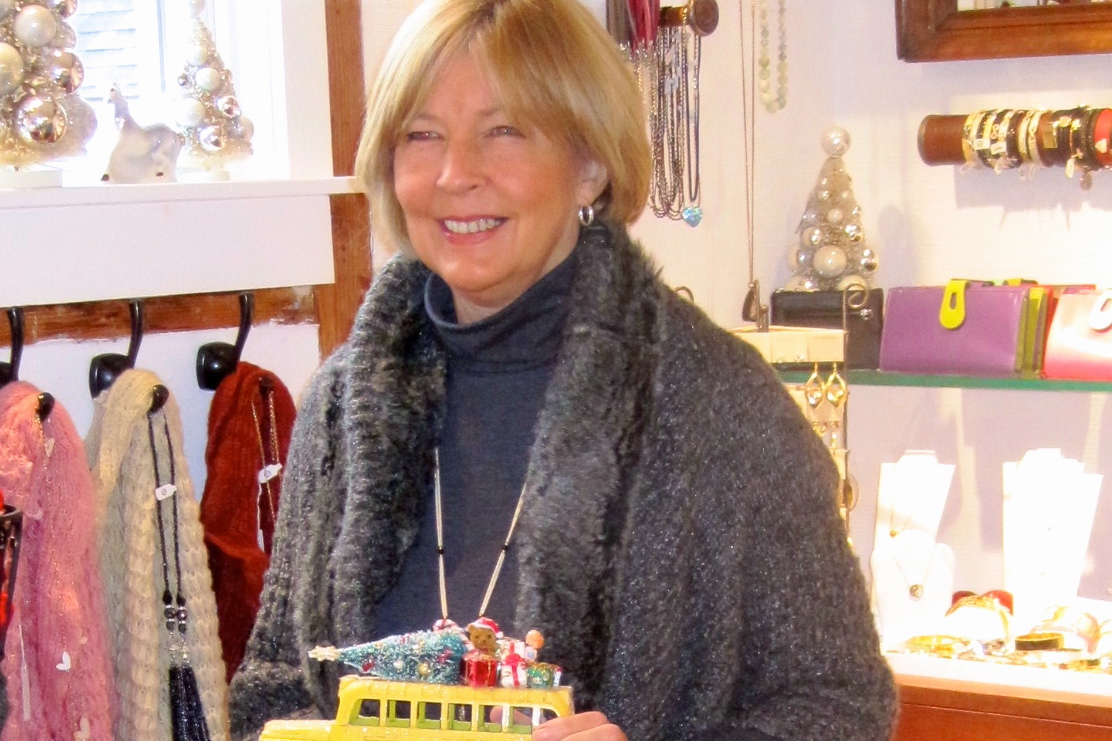 Lorraine Otto holding one of her vintage buses