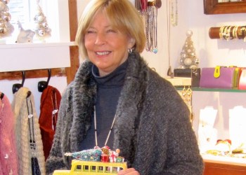 Lorraine Otto holding one of her vintage buses