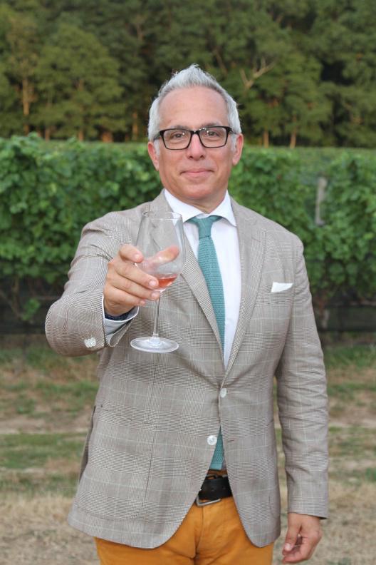 Geoffrey Zakarian at Dan's Harvest East End with a glass of McCall wine