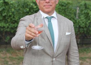 Geoffrey Zakarian at Dan's Harvest East End with a glass of McCall wine