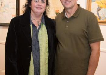 Ellen Dooley and Tom Steele stand among their works